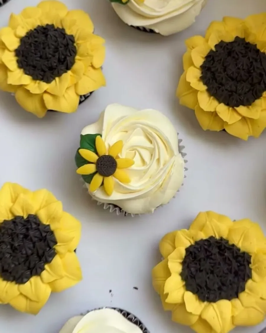 Buttercream cupcakes piped as yellow sunflowers and cream rosettes